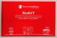 Red box with the Save the Children logo and the title “RisKIT.” The subtitle reads: “Know the risks in your area and claim your rights.” The design includes simple white line drawings of a child, houses, trees, and a group of people, with one speech bubble saying “I think so!”